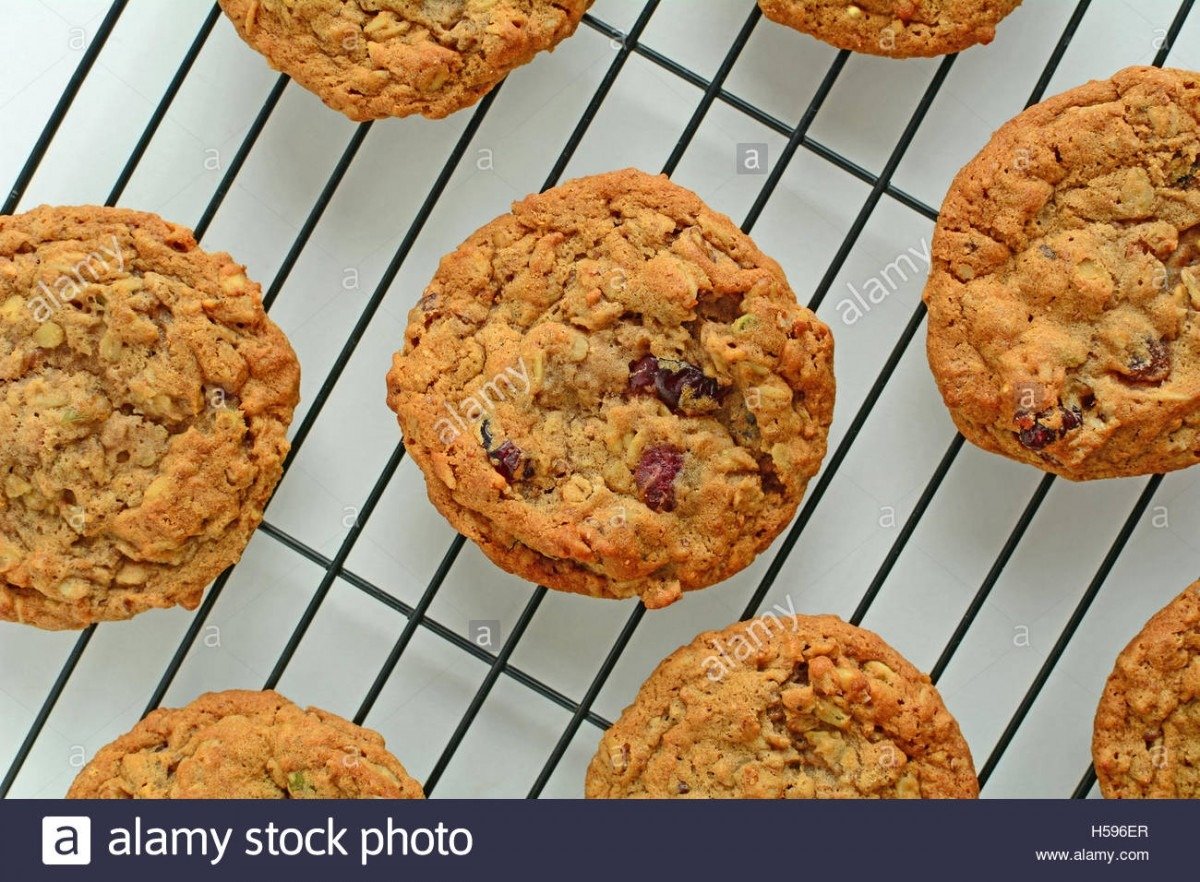 Fresh Baked Oatmeal Raisin Walnut Cookies On Black Cooling Rack